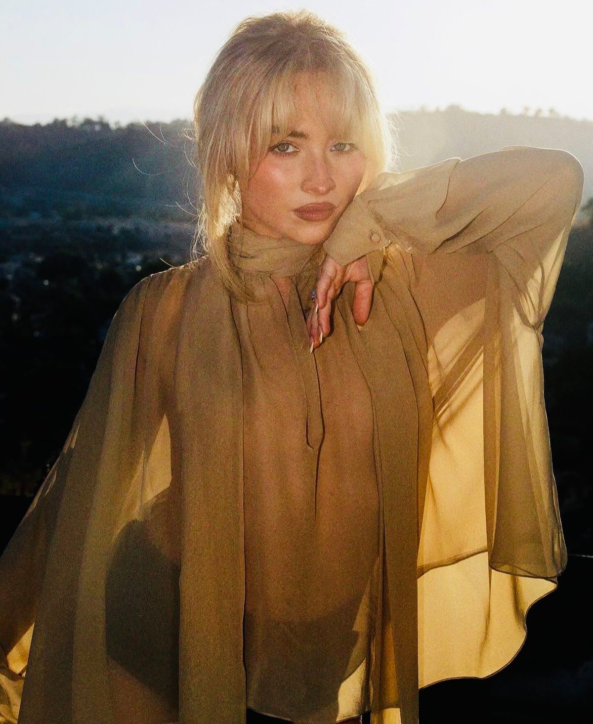 Sabrina Carpenter in a Sheer Blouse Photographed