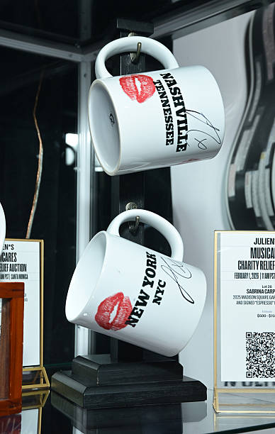Shot of mugs used and signed by Sabrina Carpenter during performances of her song "Espresso" displayed at MusiCares charity relief auction at Los Angeles Convention Center on January 29, 2026 in Los Angeles, California. (388×612)
