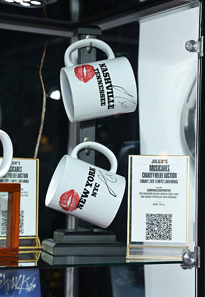 Shot of mugs used and signed by Sabrina Carpenter during performances of her song "Espresso" displayed at MusiCares charity relief auction at Los Angeles Convention Center on January 29, 2026 in Los Angeles, California. (422×612)