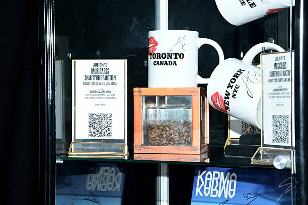 Shot of mugs used and signed by Sabrina Carpenter during performances of her song "Espresso" displayed at MusiCares charity relief auction at Los Angeles Convention Center on January 29, 2026 in Los Angeles, California. (612×408)